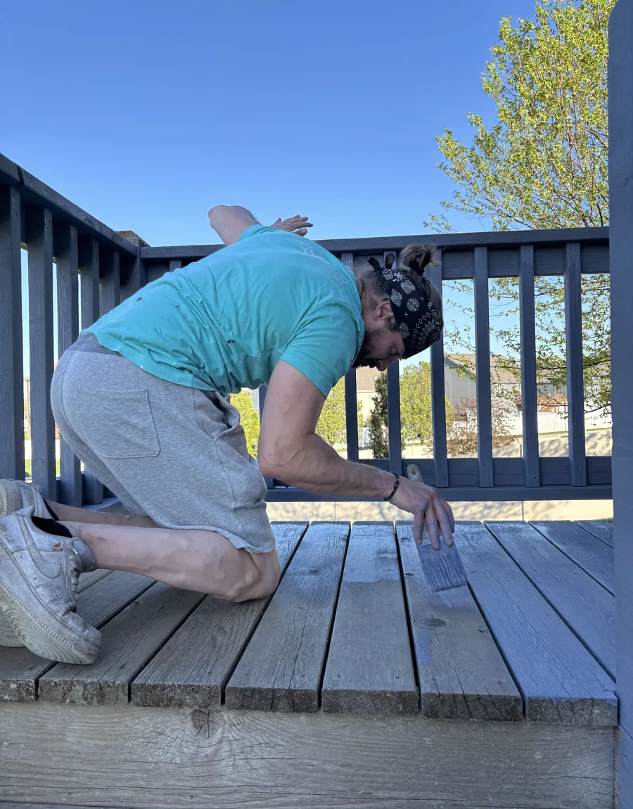 Dylan Frese, owner of Pure Paints, staining a deck